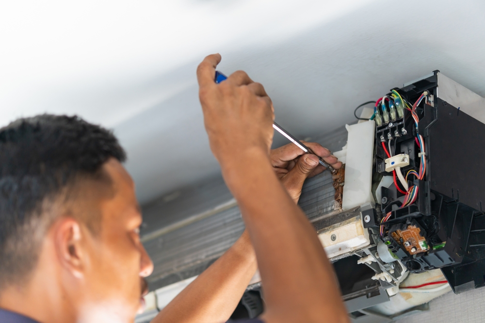 Repairman fix air conditioning systems