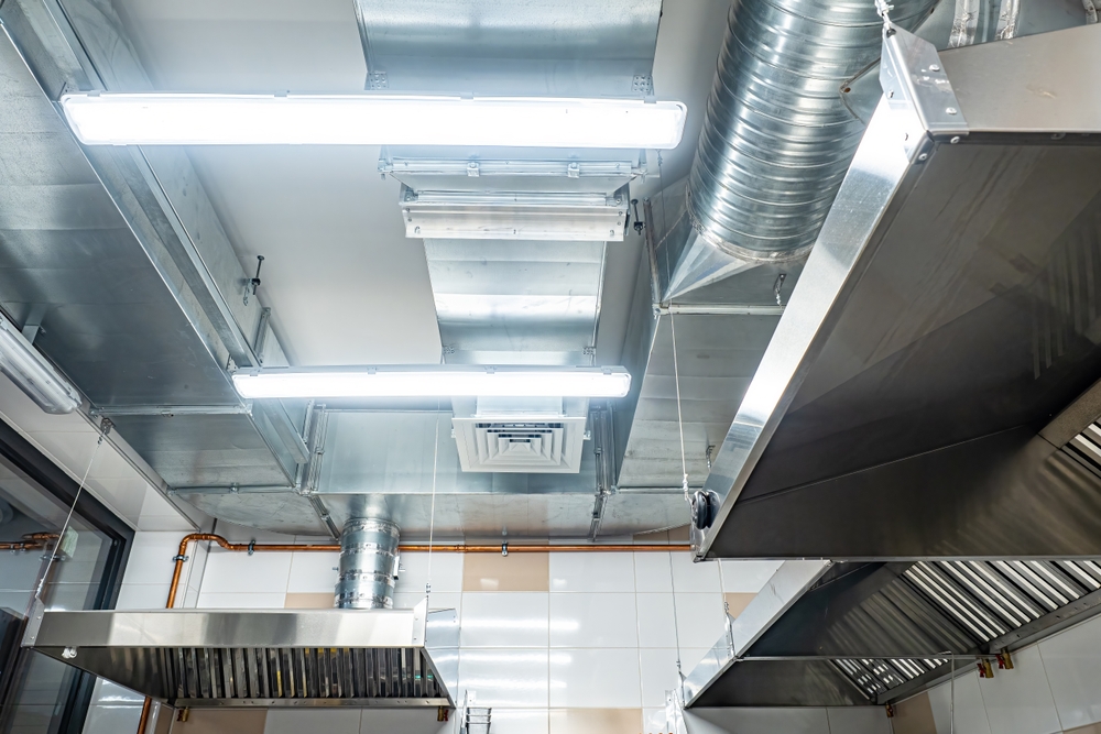Industrial kitchen ceiling with stainless steel ventilation hoods